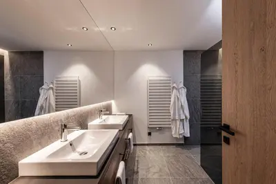a bathroom with two sinks and a shower at Residence Le Fostü in San Vigilio Di Marebbe