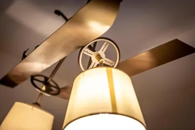 a ceiling fan with two lights hanging from it at Majon Viva in Campitello di Fassa