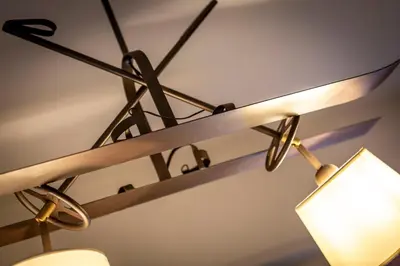 a light hanging from a ceiling with a lamp at Majon Viva in Campitello di Fassa