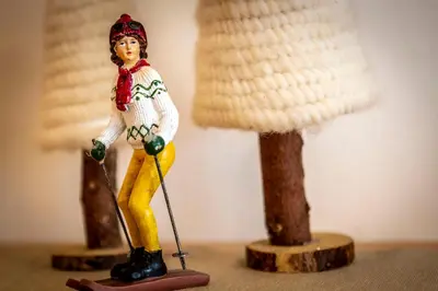 a toy figurine of a woman playing golf at Majon Viva in Campitello di Fassa