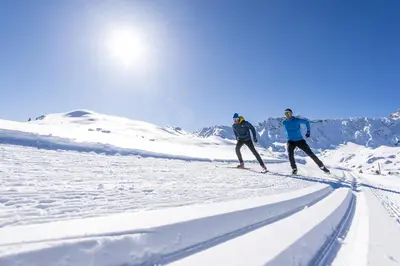two people cross country skiing in the snow at Binterhof in Castelrotto