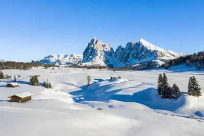 a snowy field with mountains in the background at Binterhof in Castelrotto