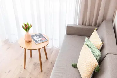 a living room with a couch and a table at Das Heacher in Merano