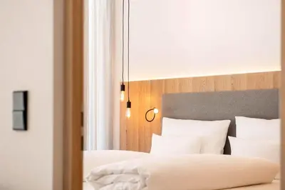 a bedroom with two beds with white pillows at Das Heacher in Merano