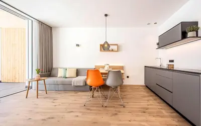 a kitchen with two chairs and a couch at Das Heacher in Merano