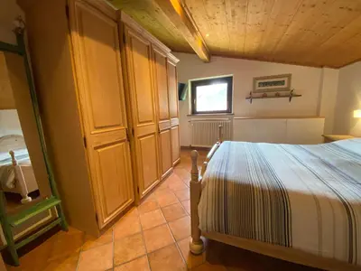 a bedroom with a bed and a window at Cèsa MeSa in Canazei