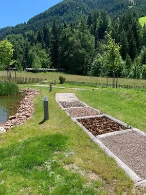 a garden with a bunch of dirt in the grass at Residence Altea in Ortisei