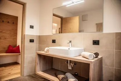 a bathroom with a sink and a mirror at Willmüllerhof in Perca