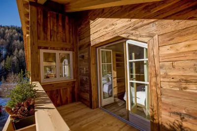 a log cabin with two windows and a balcony at Chalet Corvara in Corvara in Badia