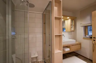 a bathroom with a shower and a sink at Chalet Corvara in Corvara in Badia