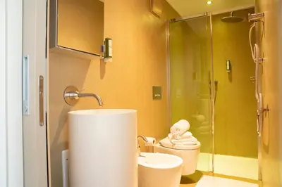 a bathroom with a toilet and a sink and a shower at Chalet Corvara in Corvara in Badia