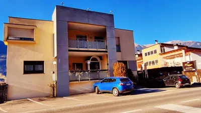 a blue car parked in front of a building at B&B Maya in Merano