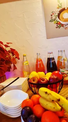 a table with bowls of fruit and bottles of juice at B&B Maya in Merano