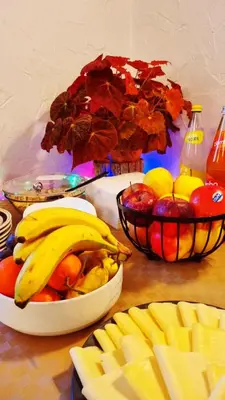 a table with a bowl of fruit and two bowls of fruit at B&B Maya in Merano