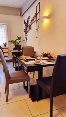 a dining room with a table and chairs with food on it at B&B Maya in Merano