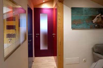 a room with a door and a picture of a horse on the wall at Apartment Luam - Alpstay in Naturno