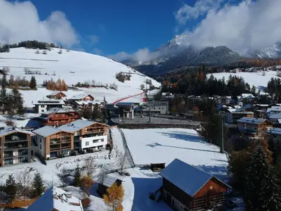 a town in the snow with a ski slope at CHALET NORA in San Vigilio Di Marebbe
