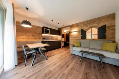 a living room with a couch and a table at CHALET NORA in San Vigilio Di Marebbe