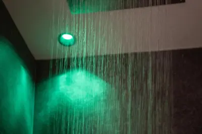 a bathroom with a shower with green lights at CHALET NORA in San Vigilio Di Marebbe