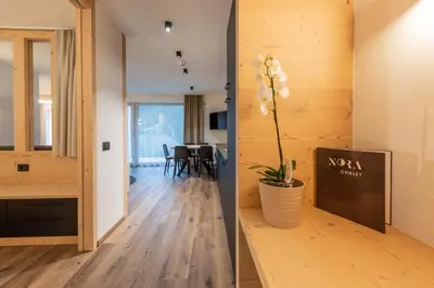 two views of a living room and a dining room at CHALET NORA in San Vigilio Di Marebbe