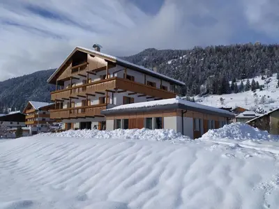 a building with snow in front of it at Residence Colibrì in Pozza di Fassa