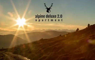 a picture of a mountain with the sun in the background at Alpine Deluxe in Riscone