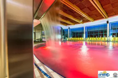 an indoor rink with red lanes in a building at Alpine Deluxe in Riscone