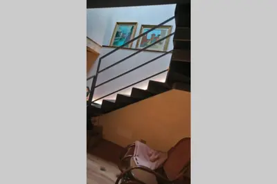 a staircase in a house with a table and chairs at La casa! in Vigo di Fassa