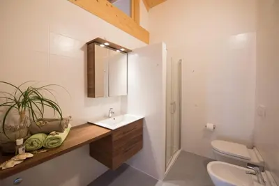 a bathroom with a sink and a toilet and a mirror at Schwarzhaus in Monticolo