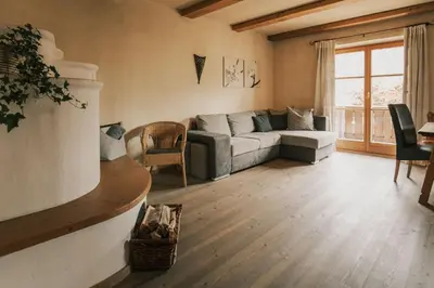 a living room with a couch and a table at Apartments Moarhof in Feldthurns