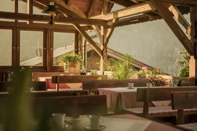 a restaurant with tables and chairs in a building at Apartments Moarhof in Feldthurns