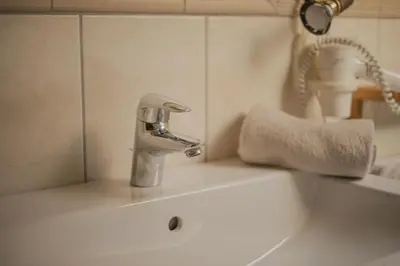 a bathroom sink with a faucet on top of it at Apartments Moarhof in Feldthurns