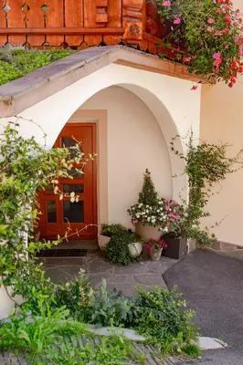 an entrance to a building with flowers and plants at haus urban in Barbiano