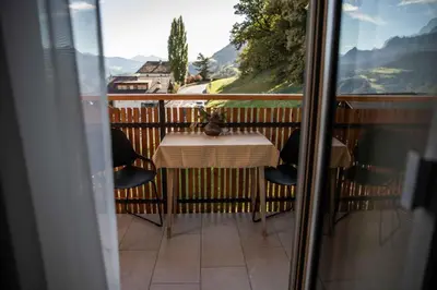 a table and chairs on a balcony with a view at haus urban in Barbiano