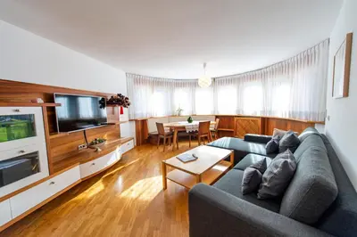 a living room with a couch and a table at Apartment Belvedere in Selva di Val Gardena