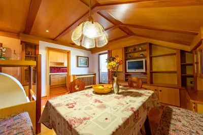 a dining room with a table with a bowl on it at Apartments Sal Feur in Selva di Val Gardena