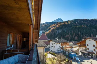 a view of a town from a balcony of a house at Apartments Sal Feur in Selva di Val Gardena