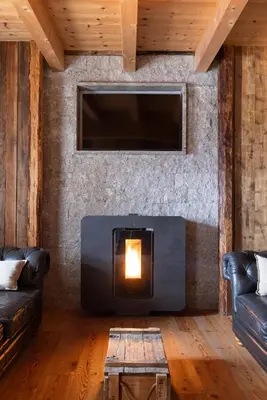 a living room with a fireplace and a tv at Studio Ebi Vacation - Alleghe - Monte Civetta in Alleghe