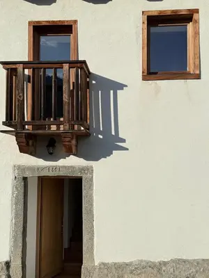 a building with a wooden balcony and two windows at Studio Ebi Vacation - Alleghe - Monte Civetta in Alleghe