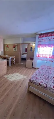 a large room with a bed and a table in it at Casa Mammolo Falcade in Falcade