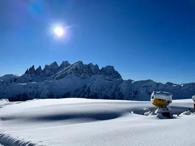 a snow covered mountain with the moon in the sky at Casa Mammolo Falcade in Falcade