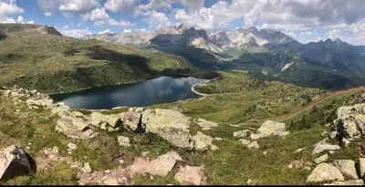 a view of a mountain range with a lake in the foreground at Casa Mammolo Falcade in Falcade