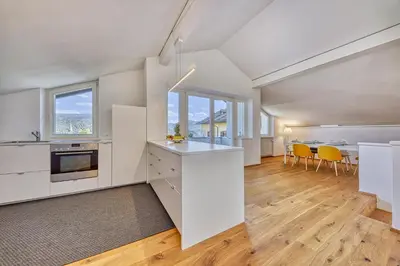 a kitchen with white cabinets and a table with yellow chairs at HOMESTWENTY3 - Home two in Caldaro