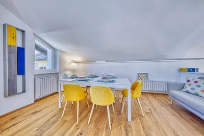 a living room with a table and chairs and a couch at HOMESTWENTY3 - Home two in Caldaro