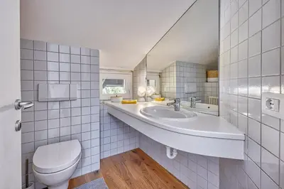 a bathroom with a sink and a toilet at HOMESTWENTY3 - Home two in Caldaro
