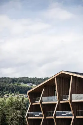 a timber building with a view of the valley at AEON Hotel - adults only Bed & Breakfast in Soprabolzano