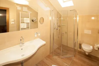 a bathroom with a sink and a glass shower at Residence Preyhof in Caldaro