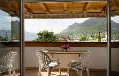 a table and chairs with a view of mountains at Residence Preyhof in Caldaro