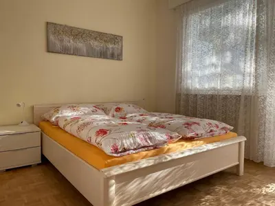 a bed with pillows on it in a bedroom at Naif-Home in Merano
