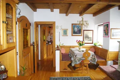a room with a table and a dining room at Casa Alpina in Cencenighe